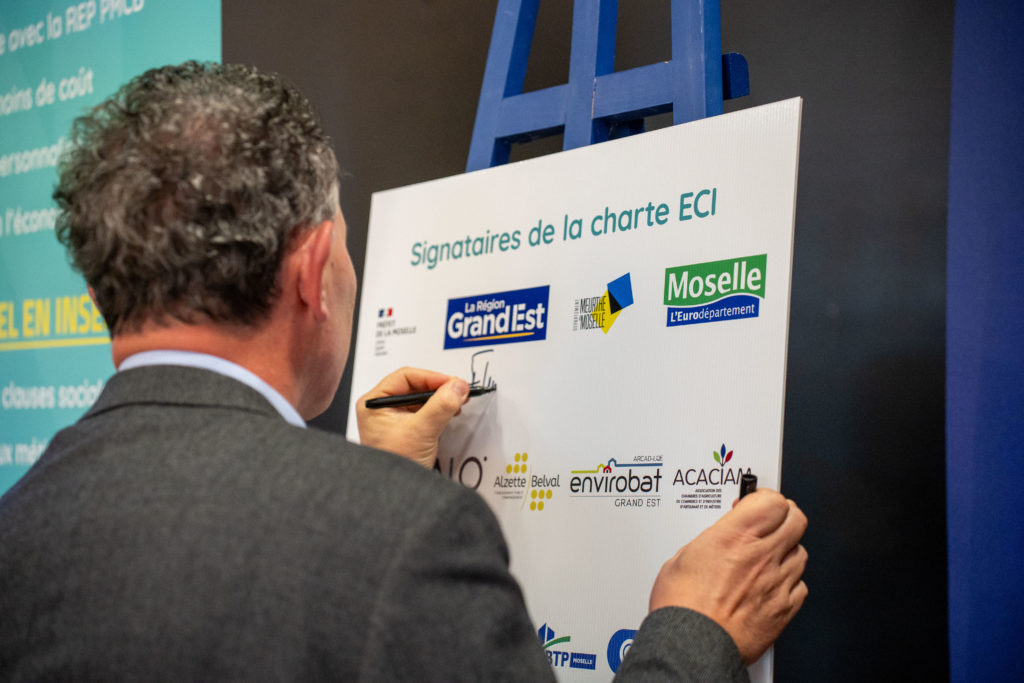 Franck Leroy, Président de la Région Grand Est, signe le panneau symbolique représentant tous les partenaires de la Charte ECI.